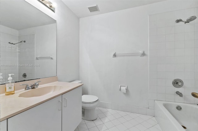 bathroom featuring tile patterned flooring, toilet,  shower combination, and vanity