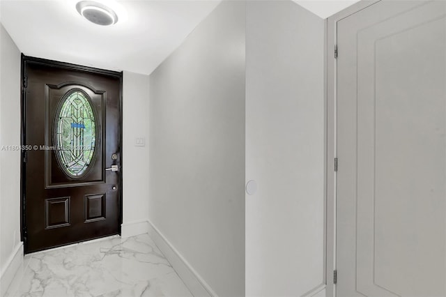 2807 NE 164th St Unit 2, North Miami Beach, FL 33160 - foyer entrance featuring marble look tile flooring and baseboards