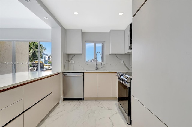 2807 NE 164th St Unit 2, North Miami Beach, FL 33160 - kitchen featuring appliances with stainless steel finishes, a sink, recessed lighting, decorative backsplash, and light marble finish flooring