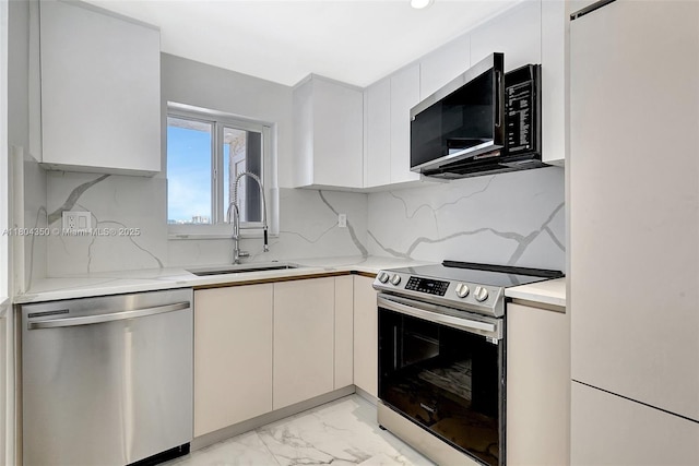 2807 NE 164th St Unit 2, North Miami Beach, FL 33160 - kitchen with stainless steel appliances, a sink, light marble finish flooring, decorative backsplash, and modern cabinets