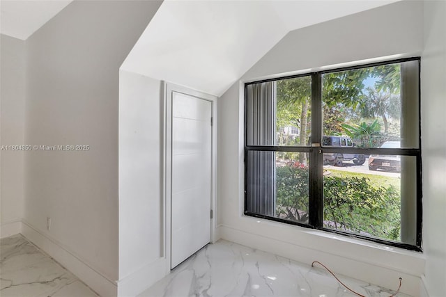 2807 NE 164th St Unit 2, North Miami Beach, FL 33160 - additional living space featuring marble look tiles, vaulted ceiling, and baseboards