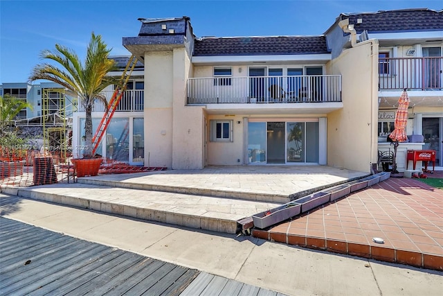 2807 NE 164th St Unit 2, North Miami Beach, FL 33160 - back of property featuring stucco siding, a patio area, and a tiled roof