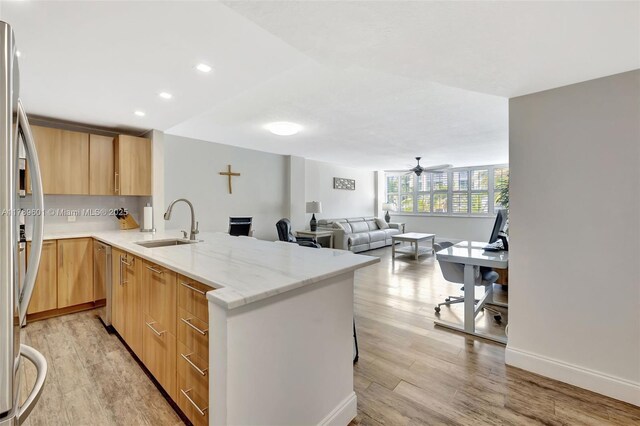 800 SE 20th Ave Unit 303, Deerfield Beach, FL 33441 - kitchen featuring a peninsula, light wood-type flooring, a sink, appliances with stainless steel finishes, and light brown cabinets