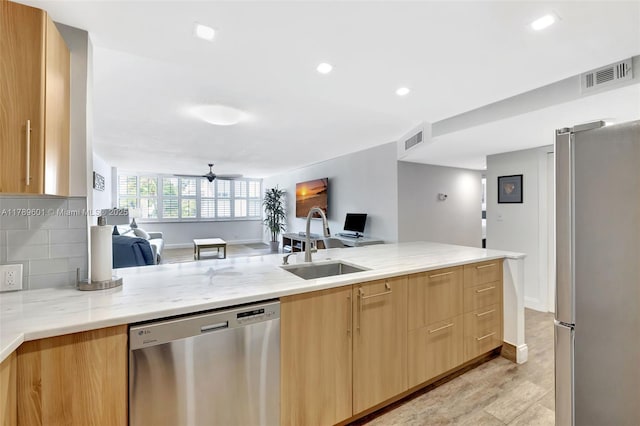 800 SE 20th Ave Unit 303, Deerfield Beach, FL 33441 - kitchen with appliances with stainless steel finishes, open floor plan, a sink, light stone counters, and recessed lighting