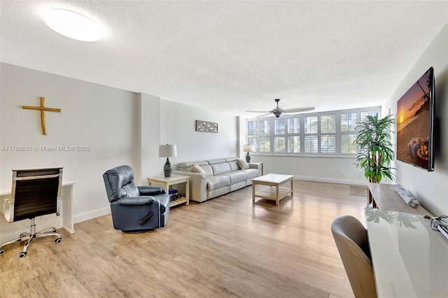 800 SE 20th Ave Unit 303, Deerfield Beach, FL 33441 - living area featuring light wood finished floors, a textured ceiling, ceiling fan, and baseboards