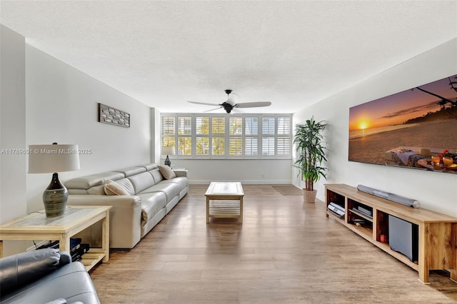 800 SE 20th Ave Unit 303, Deerfield Beach, FL 33441 - living area with ceiling fan, wood finished floors, baseboards, and a textured ceiling