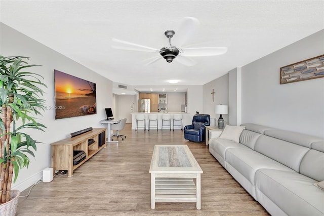 800 SE 20th Ave Unit 303, Deerfield Beach, FL 33441 - living area with light wood-type flooring, a ceiling fan, and baseboards