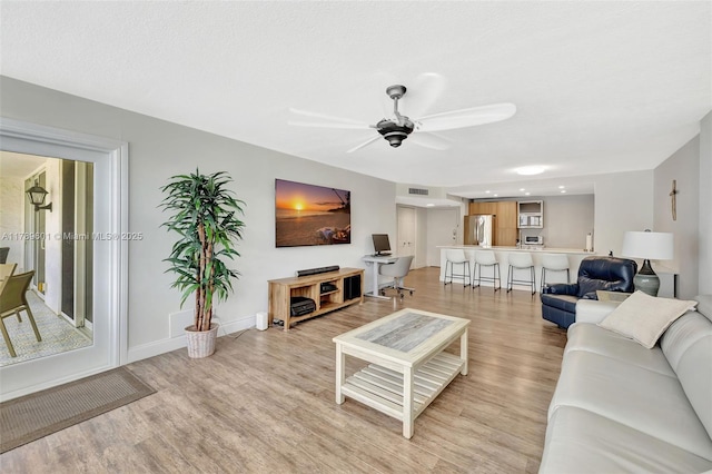 800 SE 20th Ave Unit 303, Deerfield Beach, FL 33441 - living room with light wood-type flooring, a ceiling fan, and baseboards