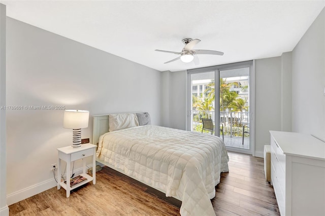 800 SE 20th Ave Unit 303, Deerfield Beach, FL 33441 - bedroom with access to exterior, baseboards, light wood-type flooring, and a ceiling fan