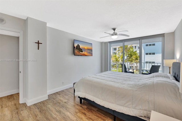 800 SE 20th Ave Unit 303, Deerfield Beach, FL 33441 - bedroom featuring baseboards, wood finished floors, access to outside, and ceiling fan