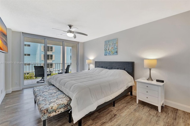 800 SE 20th Ave Unit 303, Deerfield Beach, FL 33441 - bedroom with access to outside, multiple windows, baseboards, wood finished floors, and floor to ceiling windows