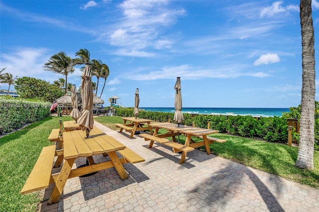 800 SE 20th Ave Unit 303, Deerfield Beach, FL 33441 - view of community featuring outdoor dining area, view of water and beach, a yard, and a gazebo