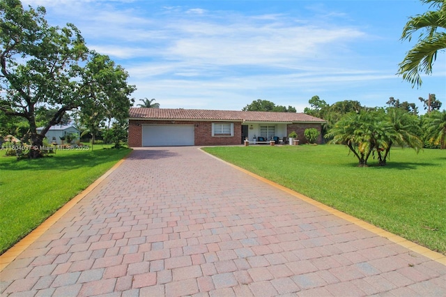 12411 SW 12th St, Davie, FL 33325 - single story home with decorative driveway, a front yard, a garage, and brick siding