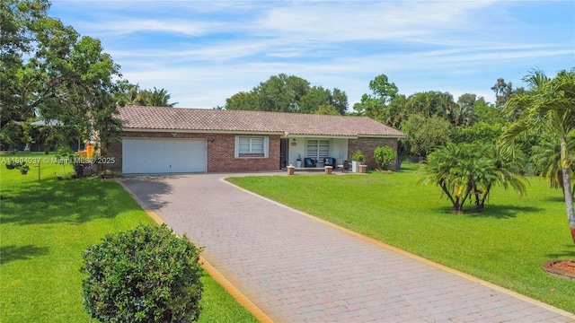 12411 SW 12th St, Davie, FL 33325 - ranch-style home featuring a garage, decorative driveway, a front lawn, and a tiled roof