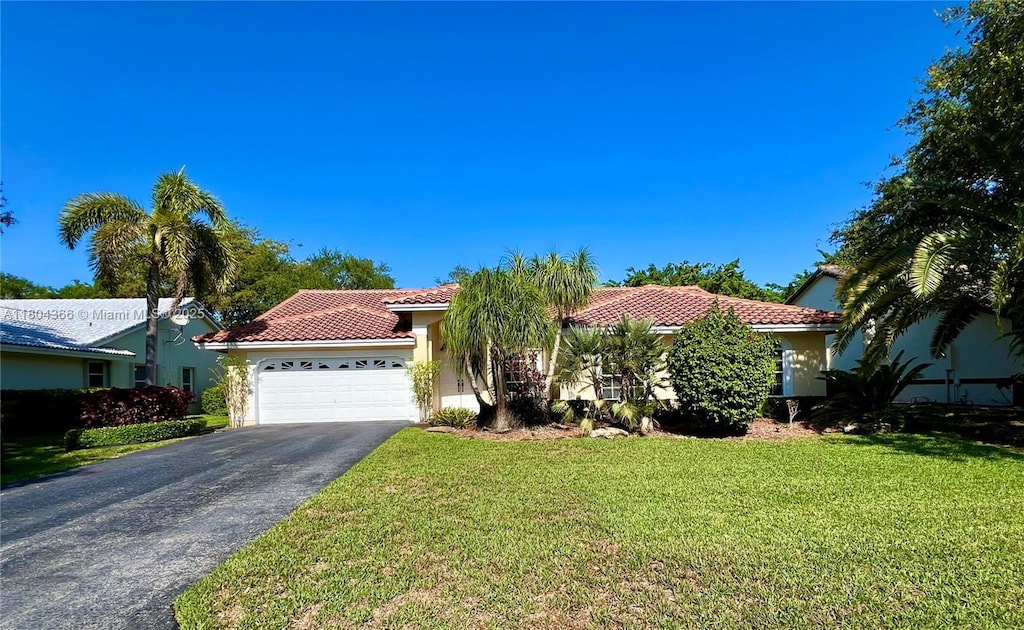 5407 NW 107th Ave, Coral Springs, FL 33076 - mediterranean / spanish house featuring a tile roof, driveway, a garage, and stucco siding