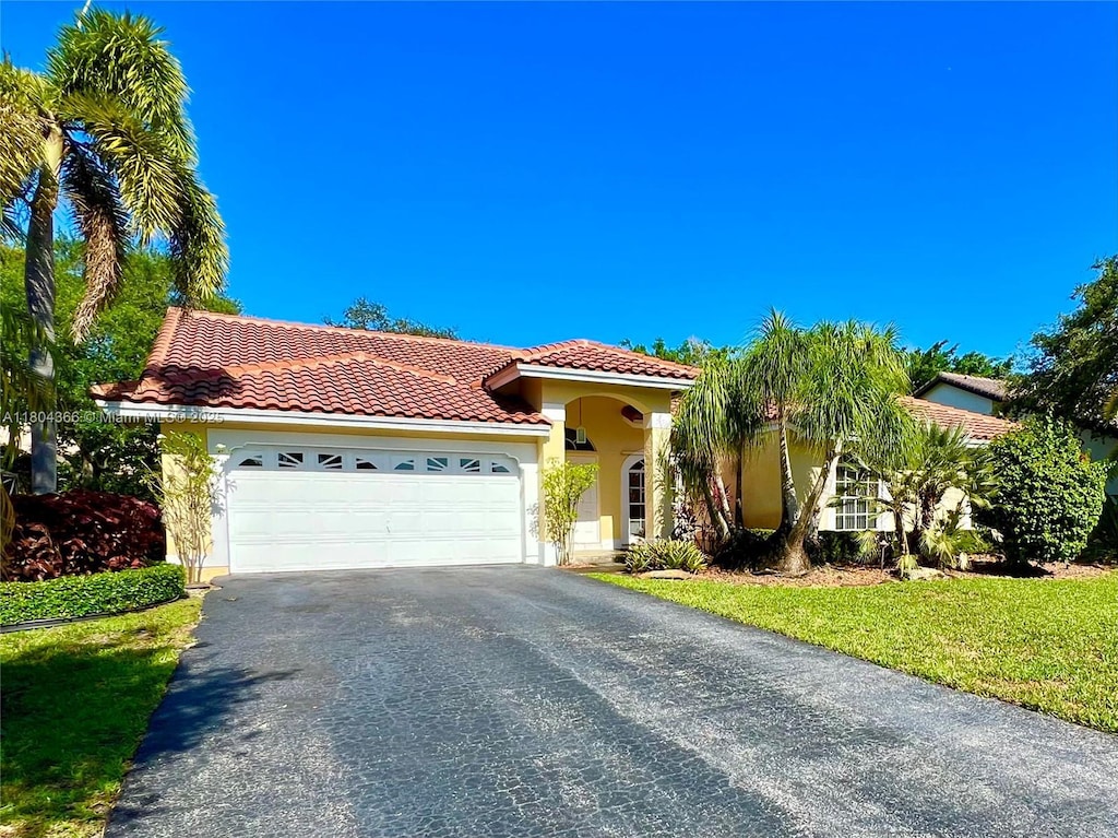 5407 NW 107th Ave, Coral Springs, FL 33076 - view of front facade featuring a tile roof, driveway, stucco siding, an attached garage, and a front lawn