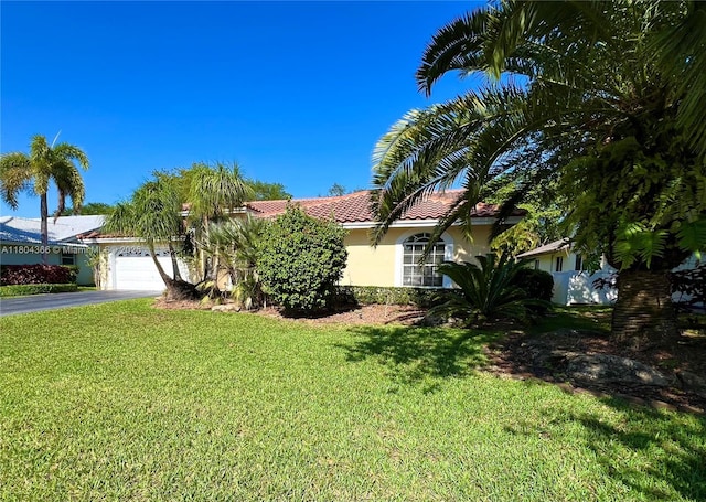 5407 NW 107th Ave, Coral Springs, FL 33076 - view of front of property featuring driveway, stucco siding, a front lawn, and an attached garage