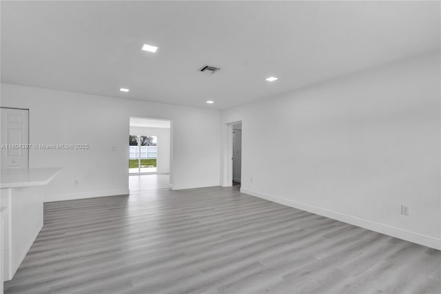 8330 NW 35th Pl, Miami, FL 33147 - empty room featuring light wood-style flooring, recessed lighting, and baseboards