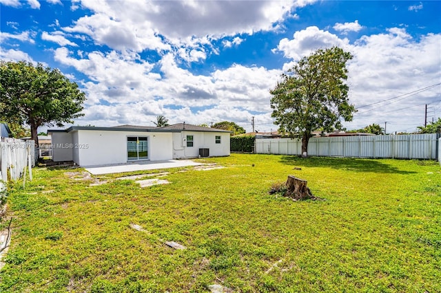 8330 NW 35th Pl, Miami, FL 33147 - back of house featuring stucco siding, central AC unit, and a patio