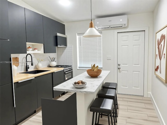 16204 NE 18th Ct, North Miami Beach, FL 33162 - kitchen with a wall unit AC, a sink, light wood-style floors, light countertops, and backsplash