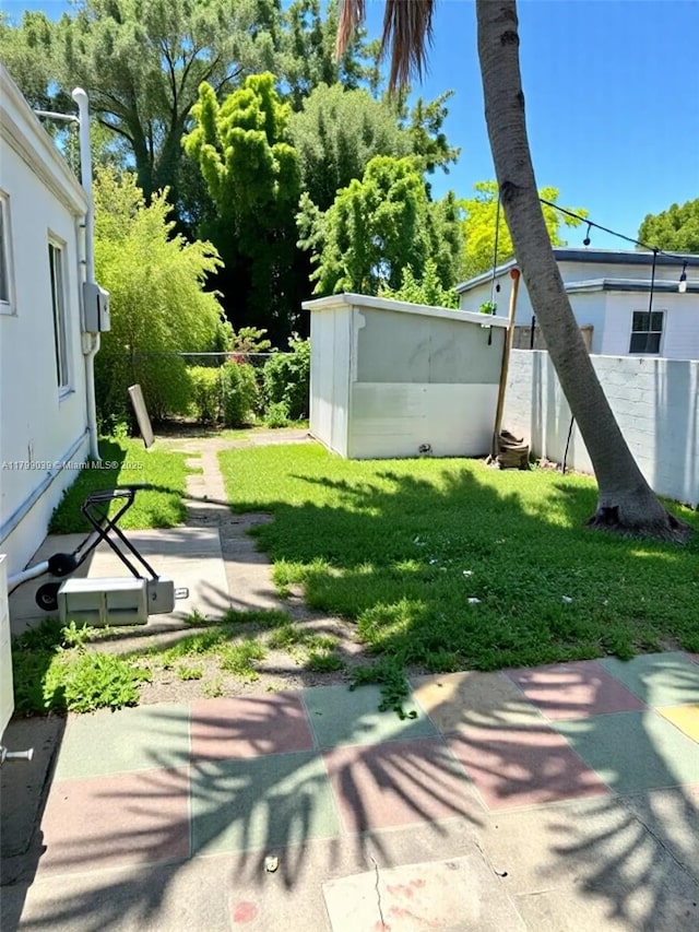 16204 NE 18th Ct, North Miami Beach, FL 33162 - view of yard featuring a patio area, an outdoor structure, and a storage shed