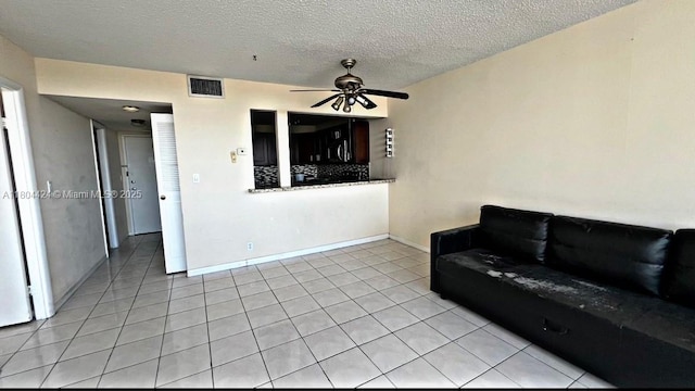 2025 NE 164th St Unit 506, North Miami Beach, FL 33162 - living area with light tile patterned floors, a ceiling fan, and a textured ceiling