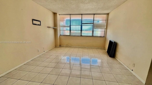 2025 NE 164th St Unit 506, North Miami Beach, FL 33162 - empty room with a textured ceiling and light tile patterned flooring