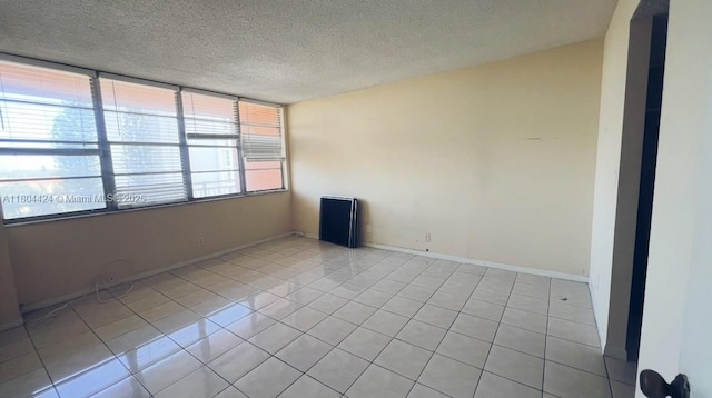 2025 NE 164th St Unit 506, North Miami Beach, FL 33162 - unfurnished room featuring light tile patterned floors and a textured ceiling