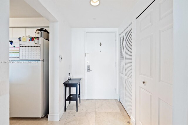 2475 Brickell Ave Unit 1805, Miami, FL 33129 - hallway featuring baseboards and marble look tiles