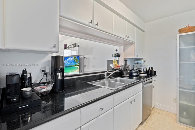 2475 Brickell Ave Unit 1805, Miami, FL 33129 - kitchen featuring dishwasher, a sink, dark countertops, white cabinets, and light tile patterned floors