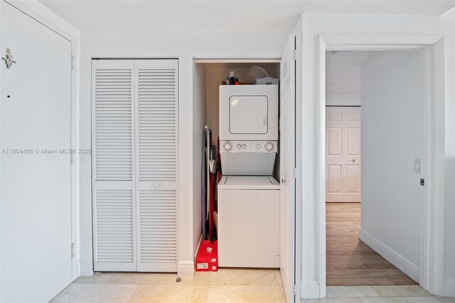 2475 Brickell Ave Unit 1805, Miami, FL 33129 - laundry area with stacked washing machine and dryer and baseboards