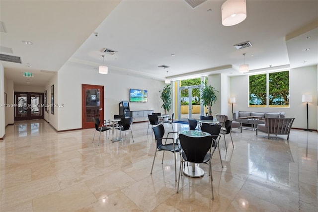 2475 Brickell Ave Unit 1805, Miami, FL 33129 - dining room with french doors, a tray ceiling, and light marble finish floors
