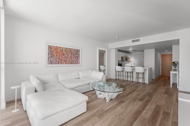 244 Biscayne Blvd Unit 2407, Miami, FL 33132 - living room with light wood-style floors