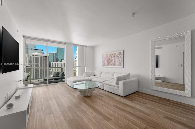 244 Biscayne Blvd Unit 2407, Miami, FL 33132 - living area featuring a wall of windows, light wood-type flooring, and a city view