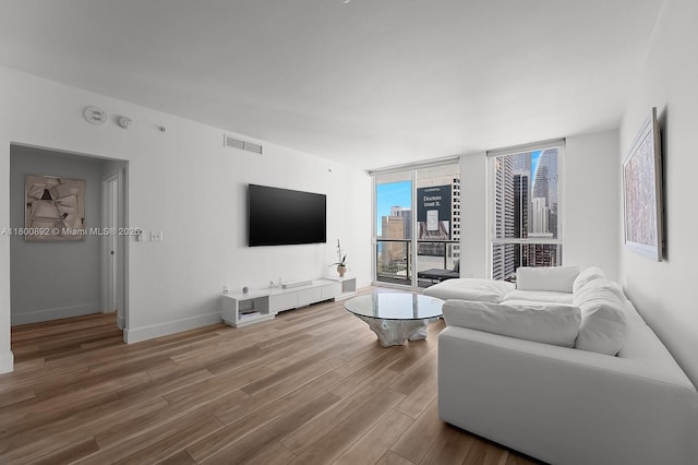 244 Biscayne Blvd Unit 2407, Miami, FL 33132 - living room featuring wood finished floors and baseboards