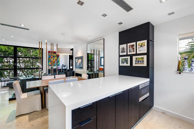 1024 Lenox Ave Unit 8, Miami Beach, FL 33139 - kitchen featuring light countertops, dishwasher, dark cabinetry, recessed lighting, and modern cabinets