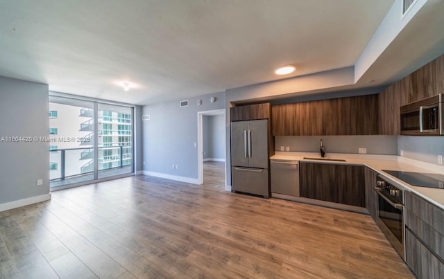 488 NE 18th Unit 2703, Miami, FL 33132 - kitchen featuring stainless steel appliances, a sink, modern cabinets, and expansive windows