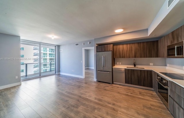 488 NE 18th Unit 2703, Miami, FL 33132 - kitchen with stainless steel appliances, modern cabinets, light countertops, a sink, and baseboards