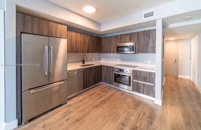 488 NE 18th Unit 2703, Miami, FL 33132 - kitchen featuring appliances with stainless steel finishes, a sink, modern cabinets, and light countertops