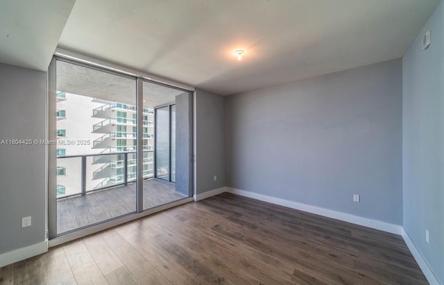 488 NE 18th Unit 2703, Miami, FL 33132 - spare room with expansive windows, wood finished floors, and baseboards