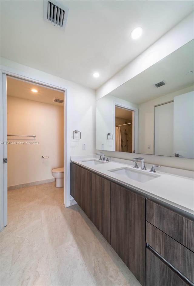 488 NE 18th Unit 2703, Miami, FL 33132 - bathroom featuring toilet, double vanity, and recessed lighting