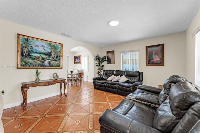 30701 SW 156th Ave, Homestead, FL 33033 - living area featuring arched walkways, a textured ceiling, and baseboards