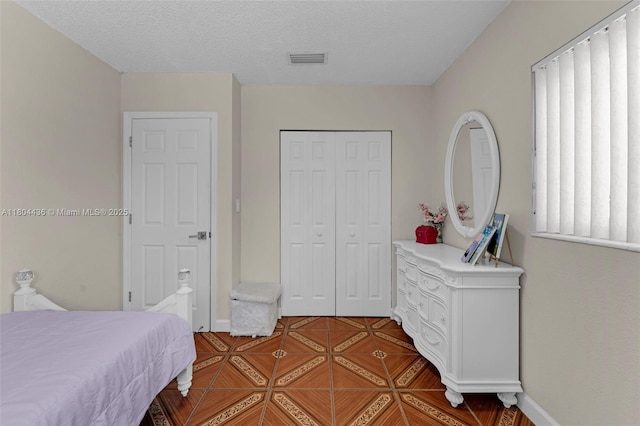 30701 SW 156th Ave, Homestead, FL 33033 - bedroom with a closet, baseboards, and a textured ceiling