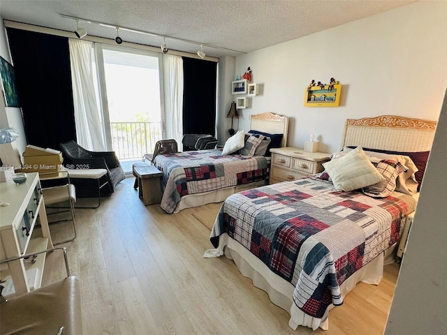 4750 S Ocean Blvd Unit 401, Highland Beach, FL 33487 - bedroom featuring light wood finished floors, track lighting, and access to exterior
