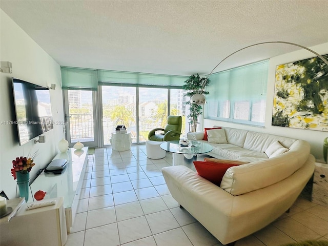 4750 S Ocean Blvd Unit 401, Highland Beach, FL 33487 - living room featuring light tile patterned floors, a textured ceiling, and floor to ceiling windows