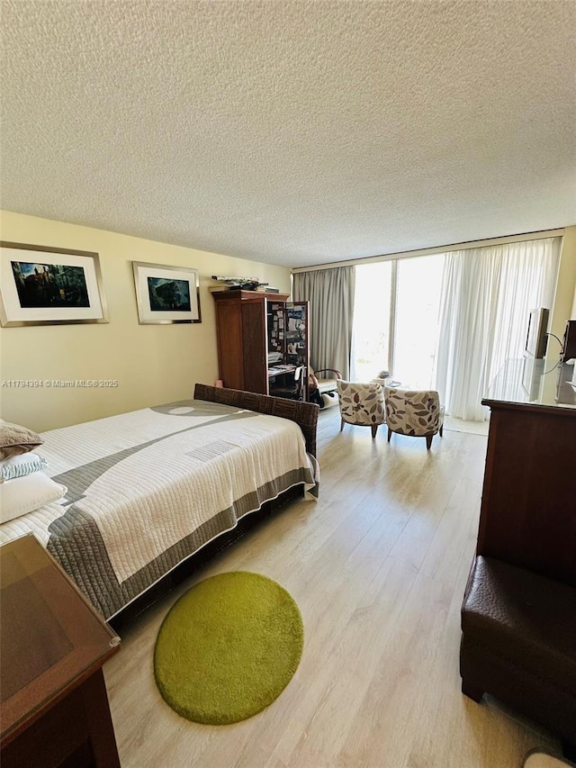 4750 S Ocean Blvd Unit 401, Highland Beach, FL 33487 - bedroom featuring wood finished floors and a textured ceiling