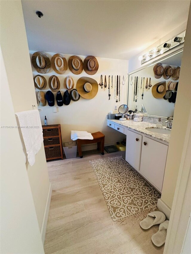 4750 S Ocean Blvd Unit 401, Highland Beach, FL 33487 - bathroom with wood finished floors, vanity, and baseboards