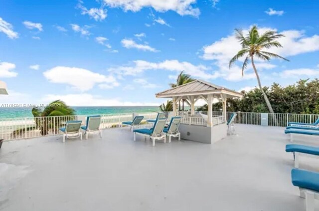4750 S Ocean Blvd Unit 401, Highland Beach, FL 33487 - view of patio / terrace featuring a gazebo, a water view, and fence