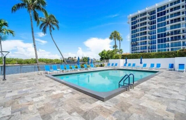4750 S Ocean Blvd Unit 401, Highland Beach, FL 33487 - community pool with a patio area and fence