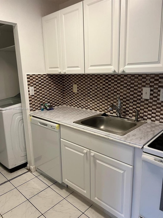 927 NE 199th St Unit 102, Miami, FL 33179 - kitchen with white dishwasher, a sink, white cabinets, light marble finish flooring, and light countertops